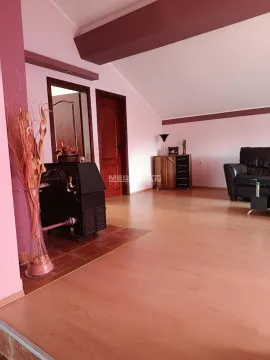 Spacious living room with laminate flooring, a pellet stove, and a sofa set. - image 4