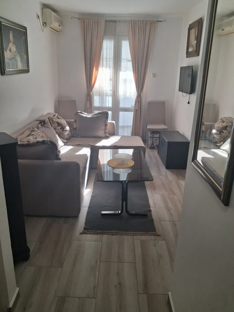 Living room with a sofa, coffee table, and access to the terrace.
