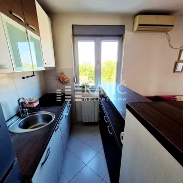 Smaller kitchen with cabinetry and a window. - image 4