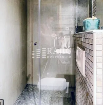 Modern bathroom with a walk-in shower and mosaic tiles. - image 8
