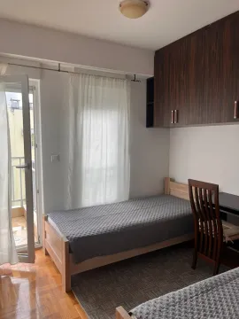 Furnished bedroom with a bed, desk, and access to the terrace. - image 8