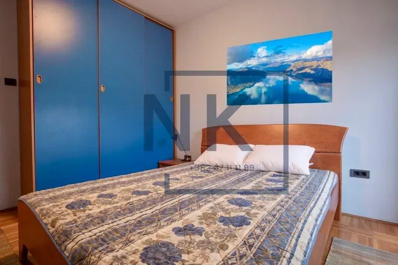 Bedroom with a double bed and a blue wardrobe.