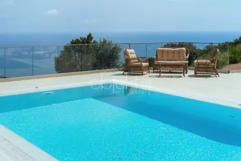 Outdoor swimming pool with seating area and sea view. - image 7