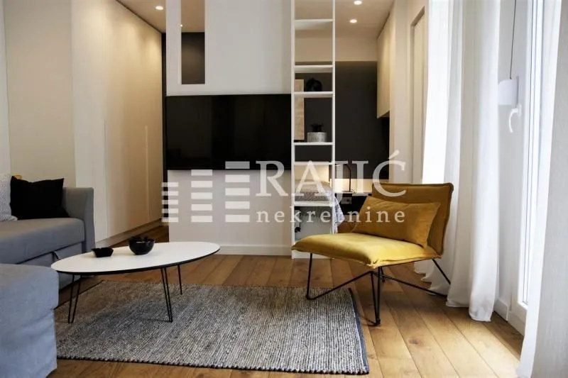 Modern living room with a sofa and armchair.