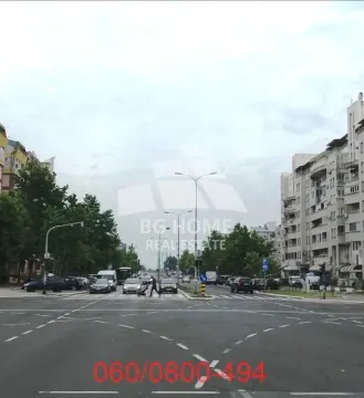 View of the city street and surrounding buildings with traffic. - image 4