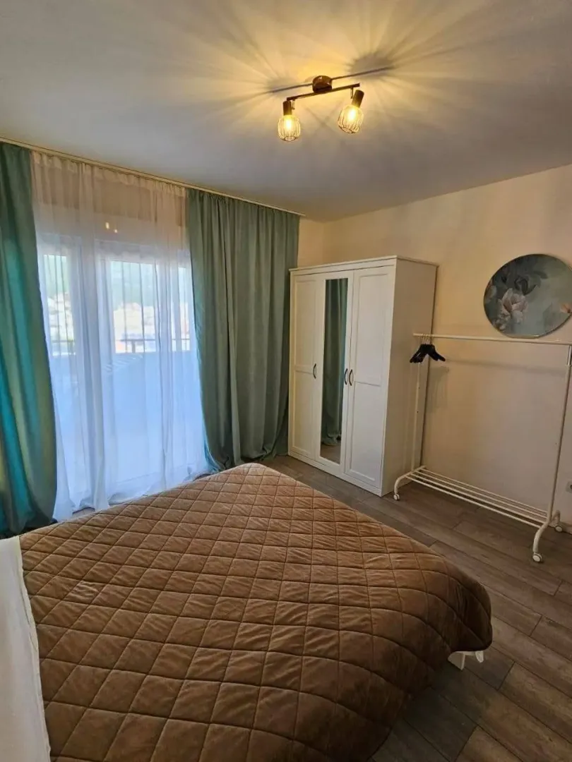Furnished bedroom with a double bed, wardrobe, and access to the terrace.