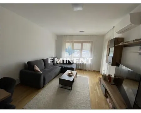 Living room with a corner sofa, coffee table and TV. - image 2