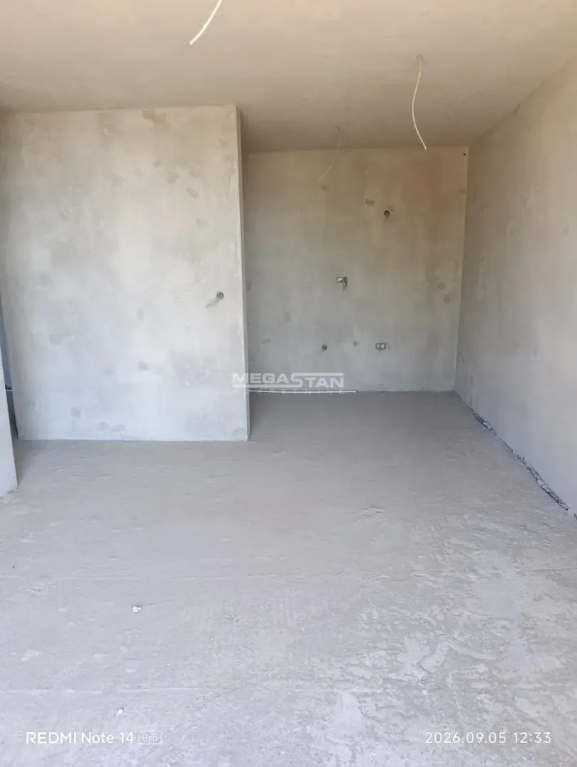 View of an unfurnished room under rough construction.