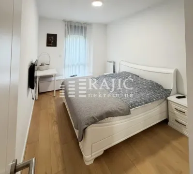 Bright bedroom with a large double bed and hardwood flooring. - image 8