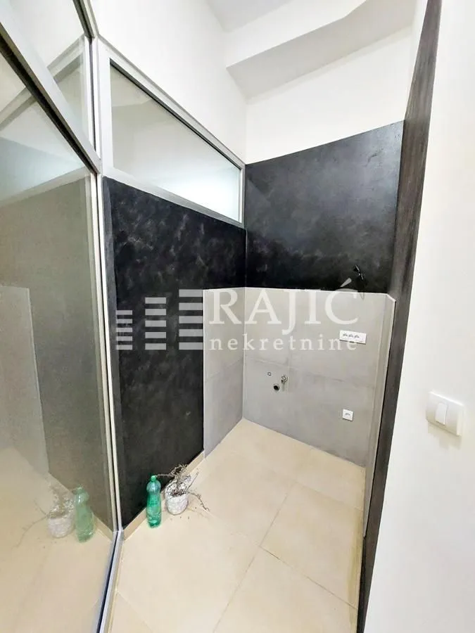 Smaller bathroom with a walk-in shower and ceramic tiles.