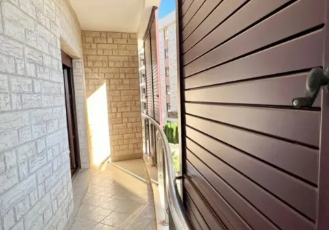 A narrow balcony featuring decorative stone walls and brown shutters. - image 6