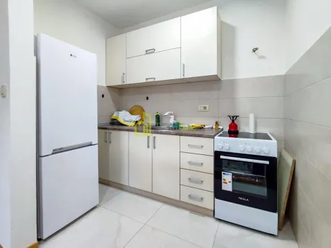 Small kitchen with white cabinets, stove and refrigerator. - image 7