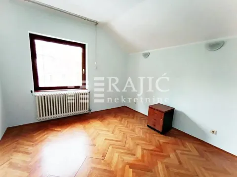 Empty room with hardwood flooring and a window. - image 11