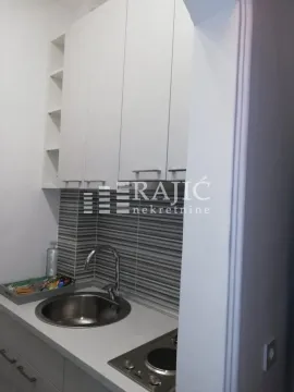 Small white kitchen with a sink and built-in hob. - image 6