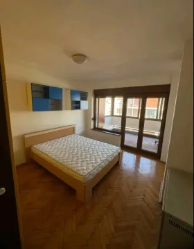 Bedroom with a double bed, wooden parquet flooring, and access to the terrace. - image 3