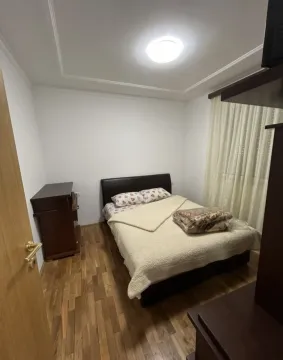 Small bedroom with a double bed, wooden flooring, and a chest of drawers. - image 4