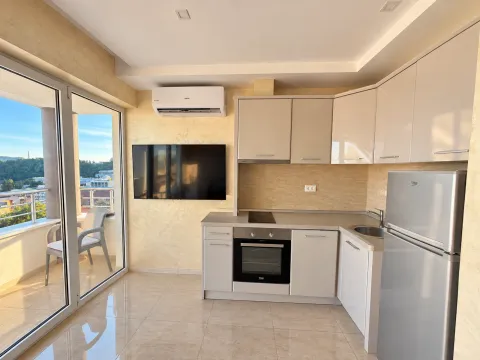 Modern kitchen connected to the dining area with access to the terrace. - image 3