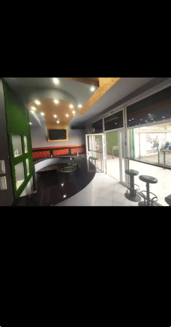 Kitchen with a bar counter and bar stools.