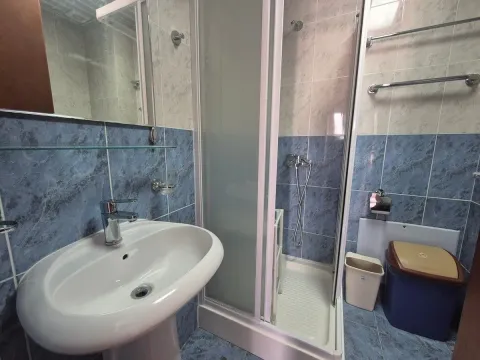 Bathroom with a sink and a shower cabin. - image 7