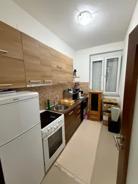 Manja kuhinja sa drvenim elementima, bijelom tehnikom i prozorom. - image 4