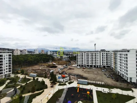 View from the apartment overlooking the building's courtyard, playground, and surrounding neighborhood under construction. - image 5