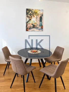 Dining table with four chairs and a painting on the wall. - image 3