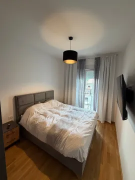 Bedroom with a double bed, nightstand, and terrace access. - image 6