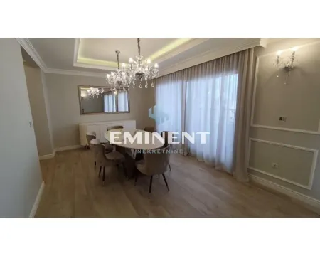 Dining area with a table, chairs, and a classical style chandelier. - image 5