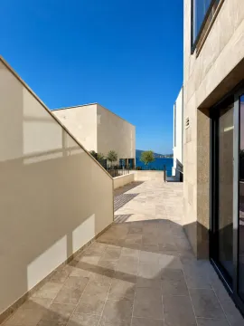 Tiled terrace of a modern building with a sea view. - image 12