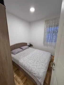 Small bedroom with a double bed and a window with a curtain. - image 5