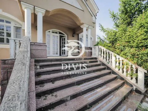 Main entrance to the house with stairs and a porch with columns. - image 4