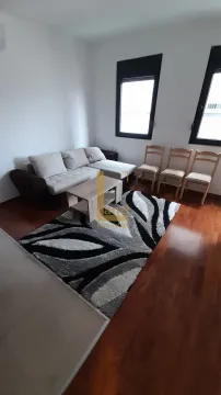 Living room with a sofa, coffee table, and rug. - image 4