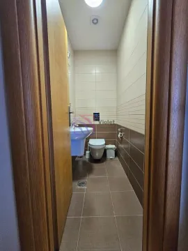 View of the bathroom with tiles and sanitary ware through the open entrance. - image 12