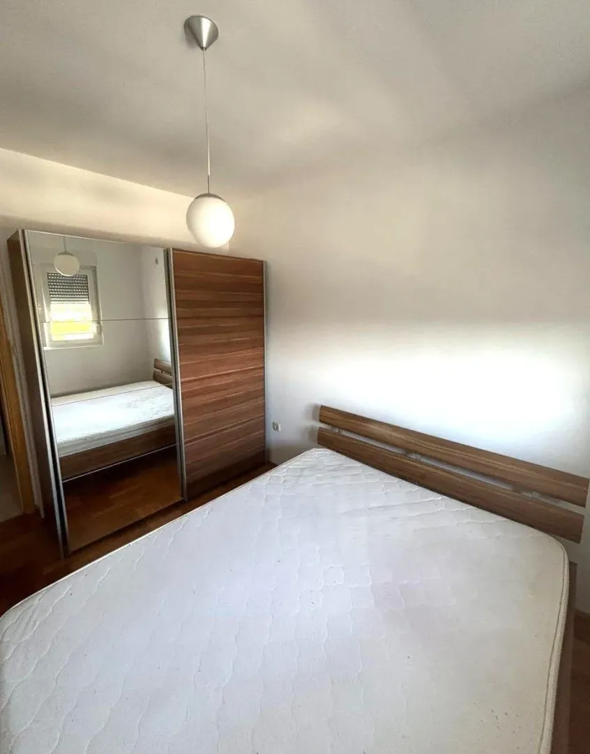 Bedroom with a double bed and a large mirrored wardrobe.