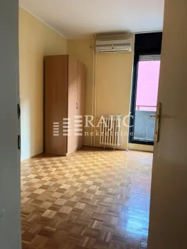 Furnished bedroom with a wardrobe and parquet flooring. - image 2