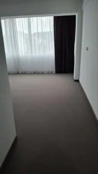 An empty room with carpet and a large window. - image 4
