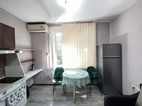Small kitchen with a dining table and chairs by the window. - image 3