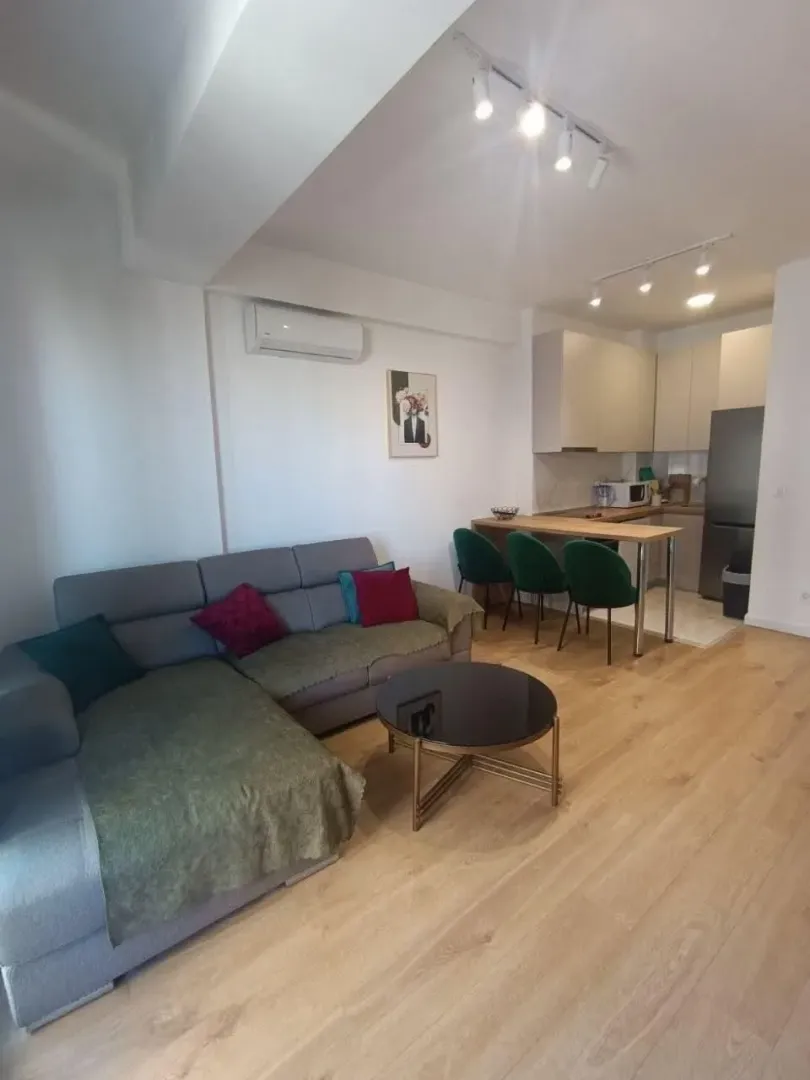 Living room with a sofa and dining area integrated with the kitchen.