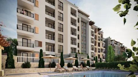 Exterior view of a modern residential building with a swimming pool and sun loungers. - image 7