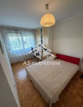 Furnished bedroom with a bed, desk, and wardrobe. - image 10