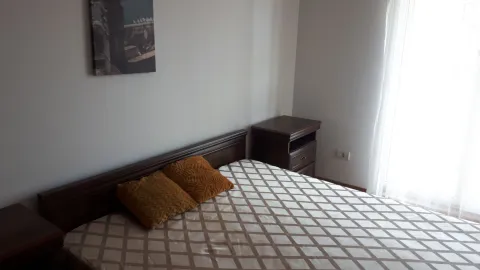 Furnished bedroom with a double bed and a nightstand. - image 2