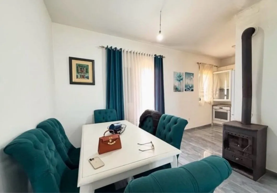 Living room with dining area and wood-burning stove.