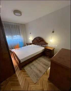 Bedroom with a double bed, bedside tables, and wooden flooring. - image 6