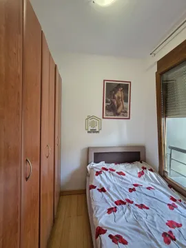 Small bedroom with a bed, built-in wardrobe, and window. - image 6