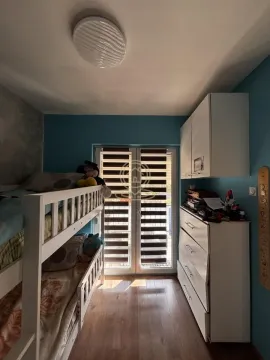 Children's bedroom with a bunk bed and blue walls. - image 7