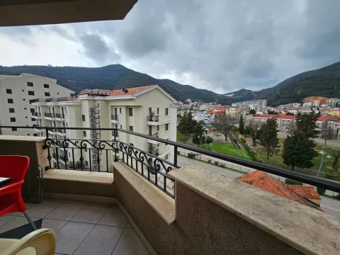 View from the balcony towards surrounding buildings, the town, and hills in the background. - image 2