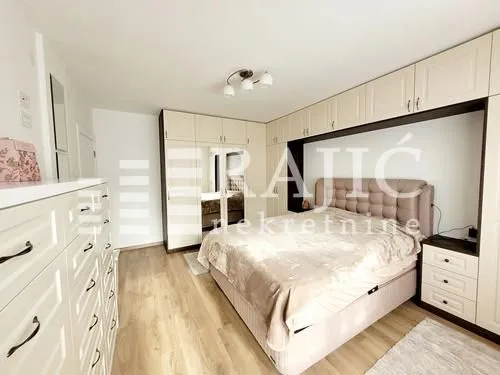 Furnished bedroom with a double bed and built-in wardrobes.