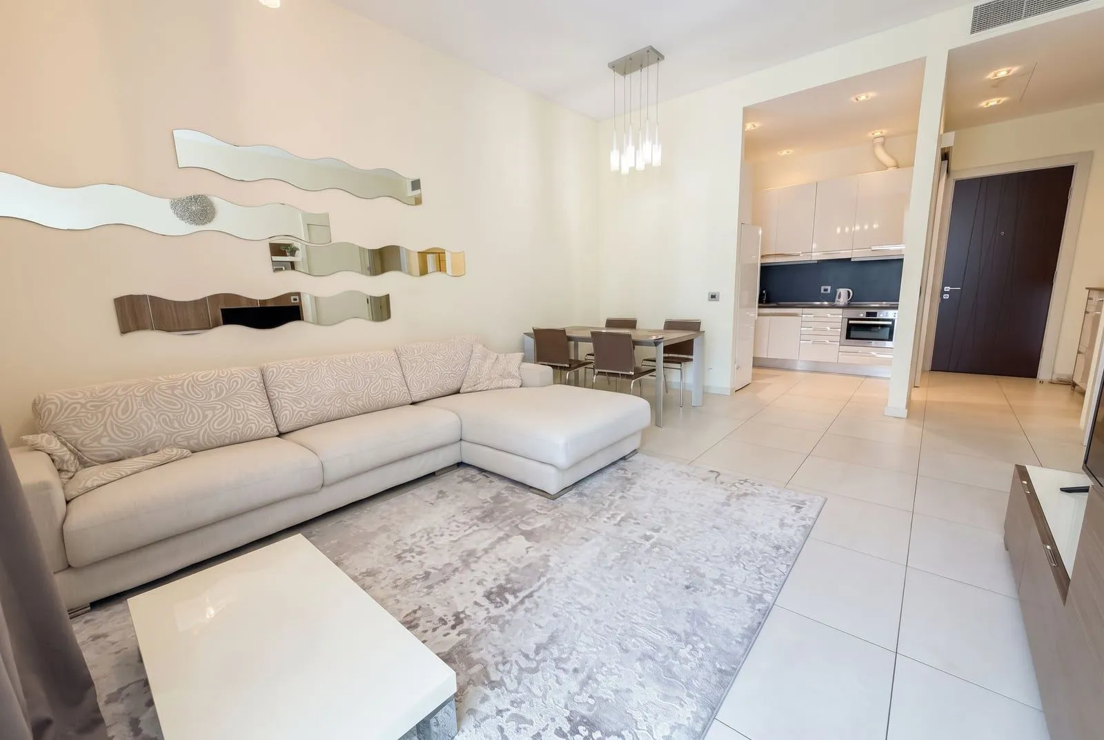 Living room with a sectional sofa and dining area in an open-plan layout.
