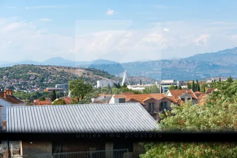 View of the city with hills and mountains in the background. - image 19