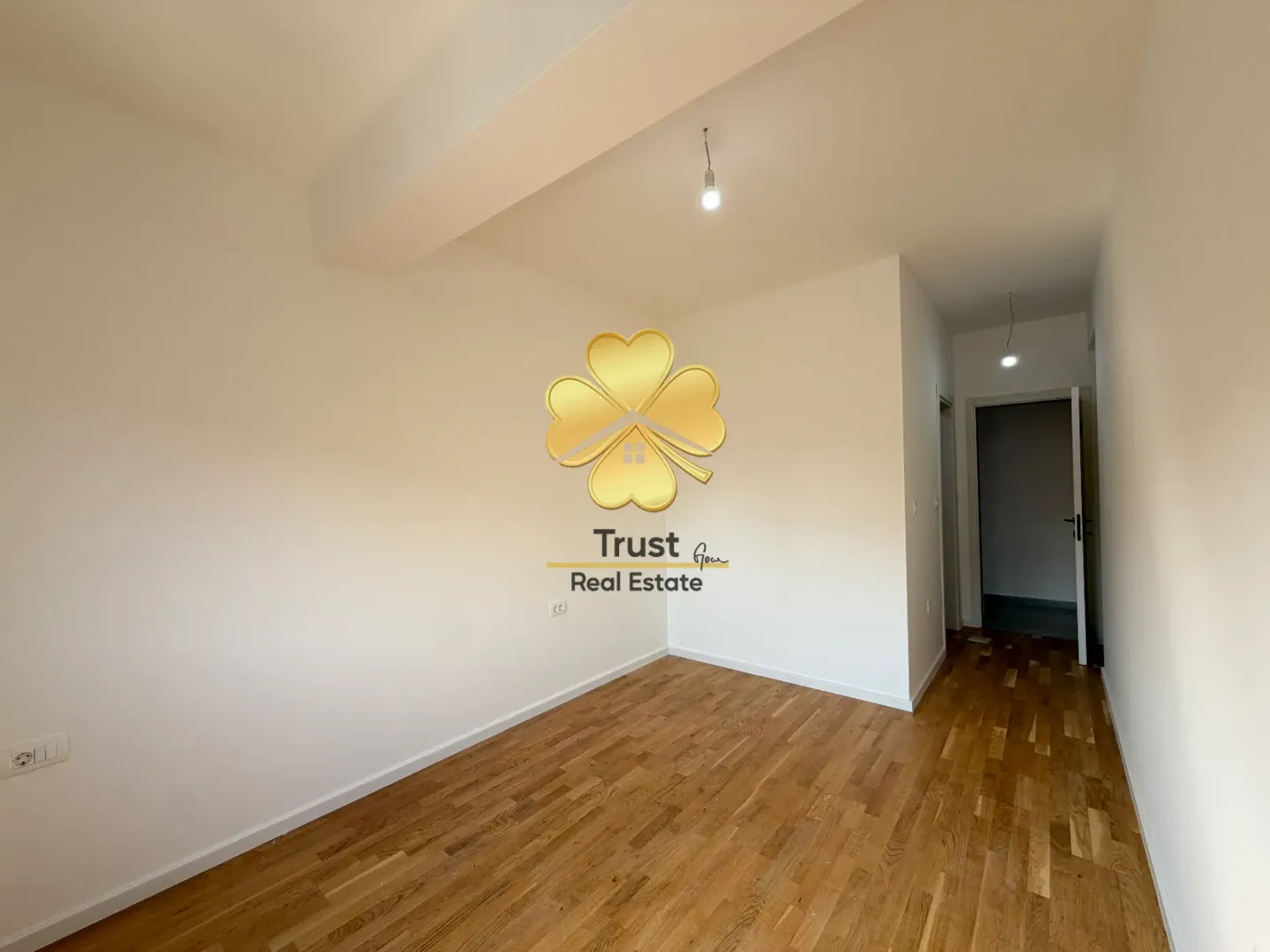 Empty room with wooden flooring and an agency watermark.